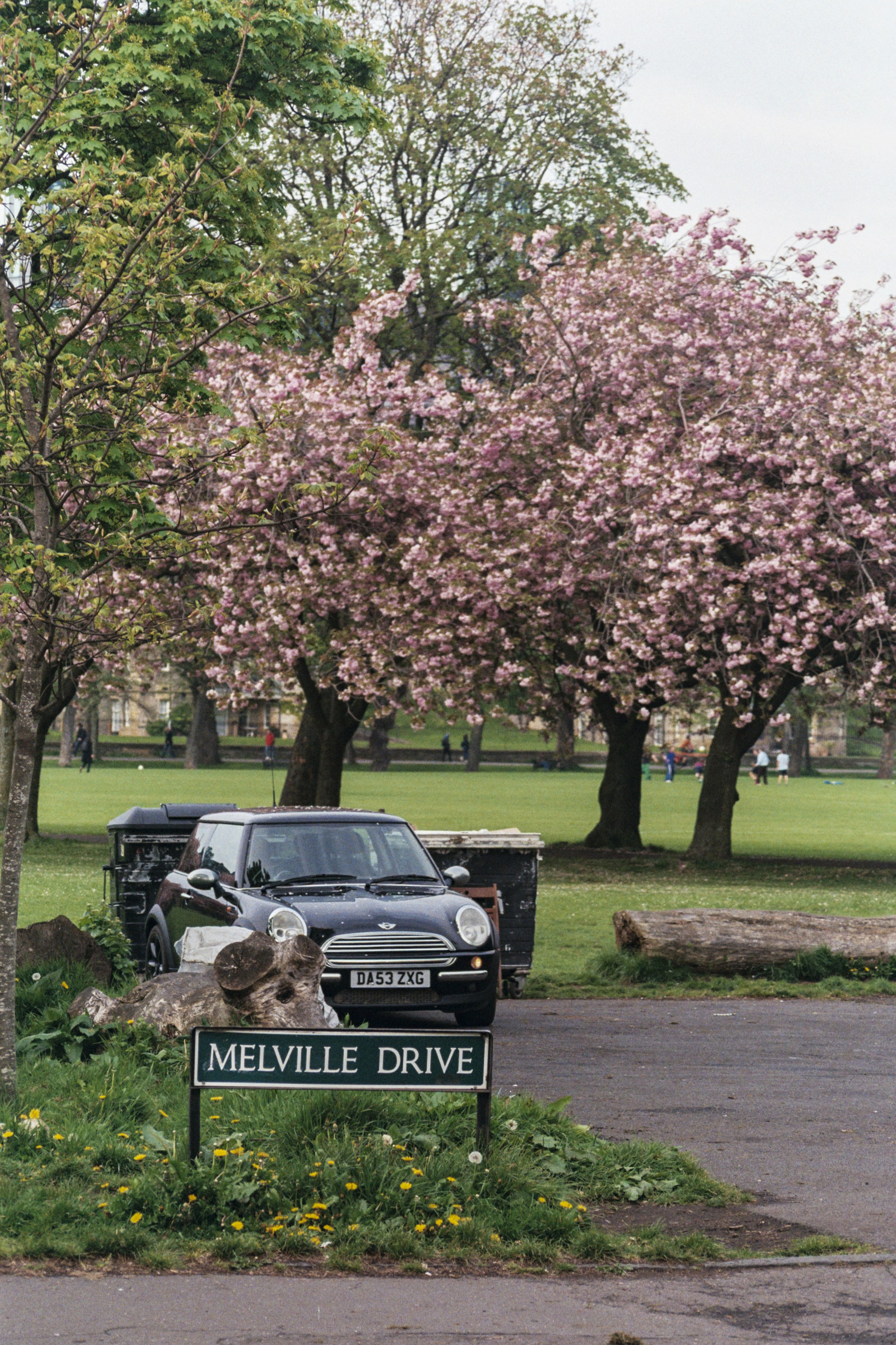 a car is parked in front of a sign