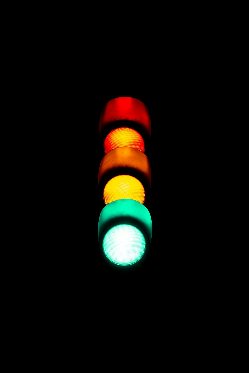 a traffic light is lit up in the dark