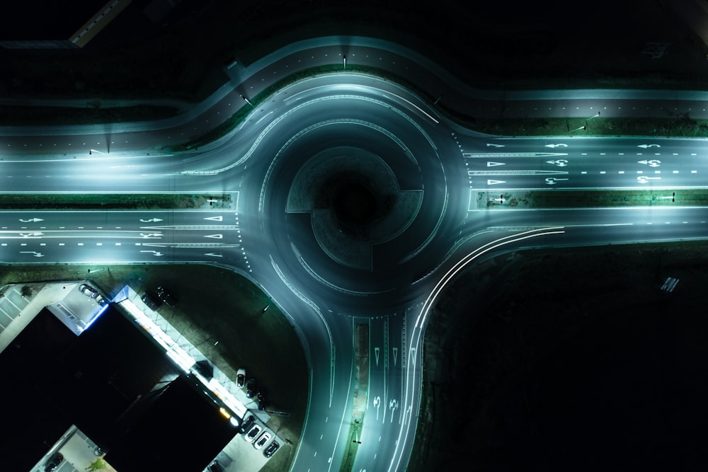 an aerial view of a highway intersection at night