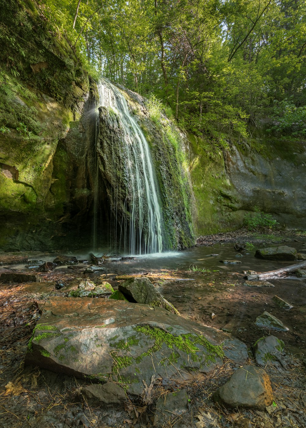 a large waterfall over a body of water