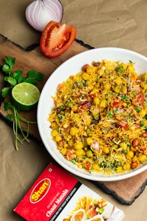 a white bowl filled with food on top of a wooden cutting board