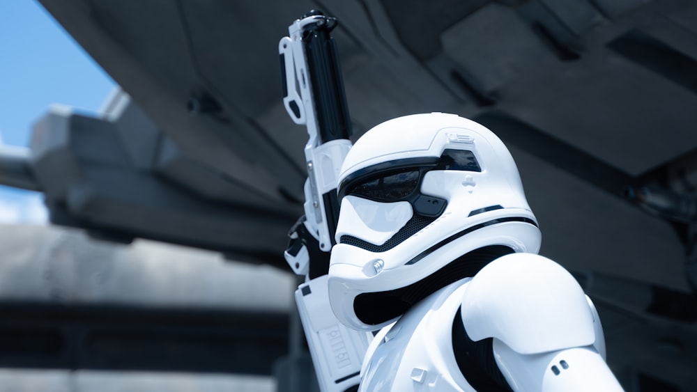 a star wars storm trooper holding a gun