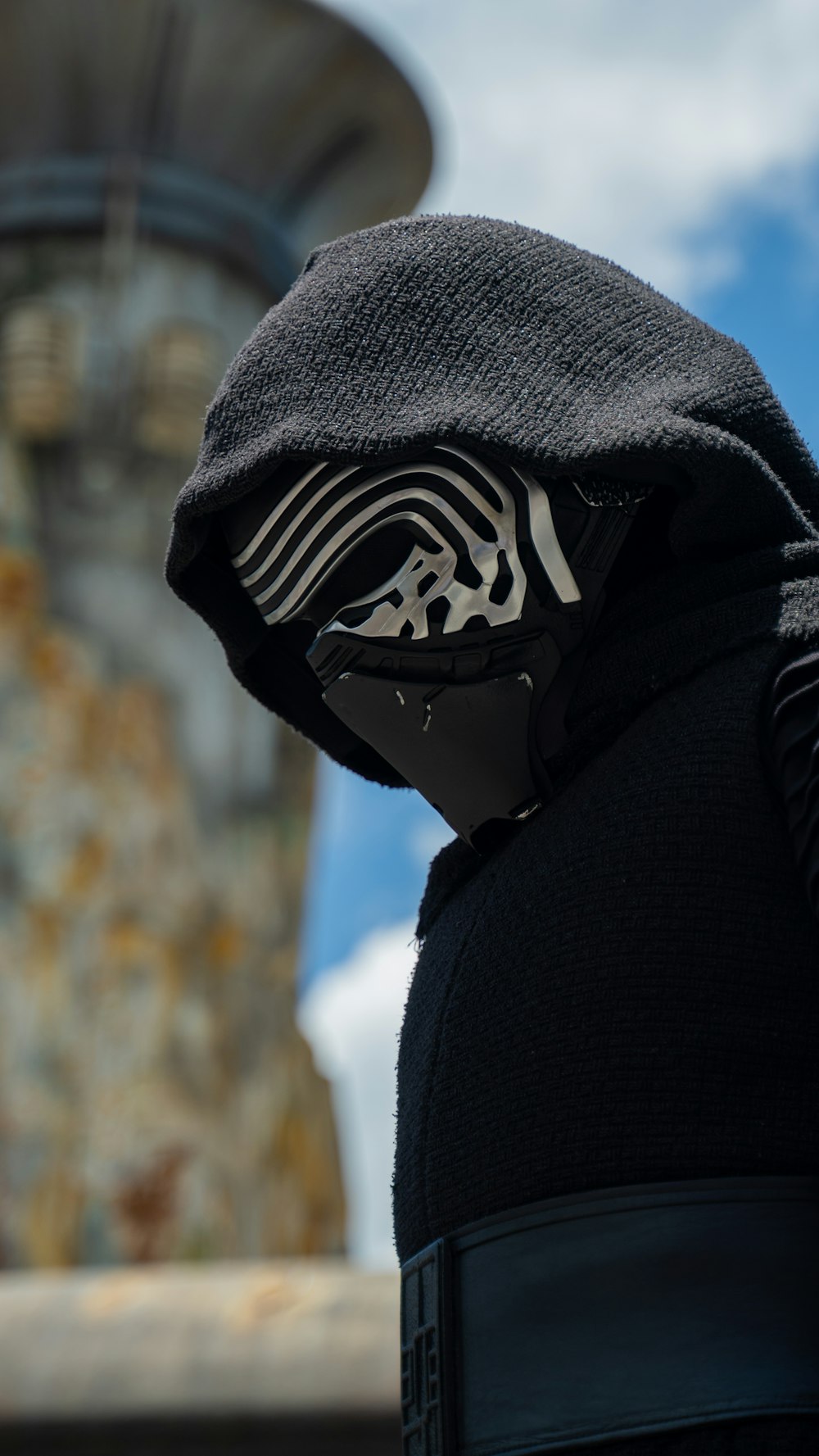 a person in a black hoodie with a star wars mask on