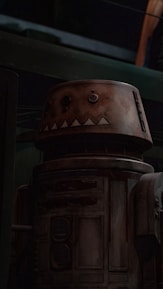 A vintage, weathered robot with a cylindrical body and a round head displaying rudimentary facial features is positioned within a dimly lit industrial setting. The surface of the robot is characterized by a rusty and rugged texture, suggesting age and wear.