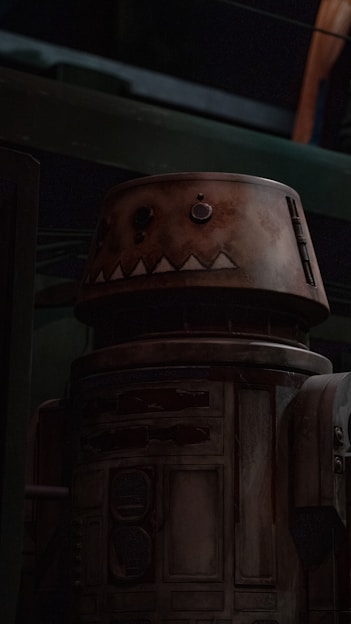 A close-up of a partially restored Heathkit Hero robot with exposed wiring and vintage components.