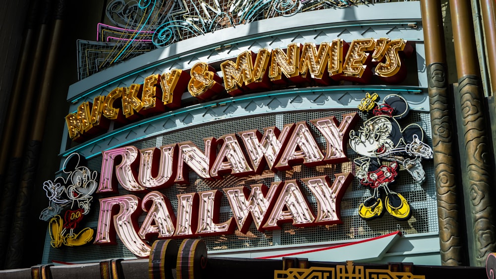 a sign for a railway station with a clock on it