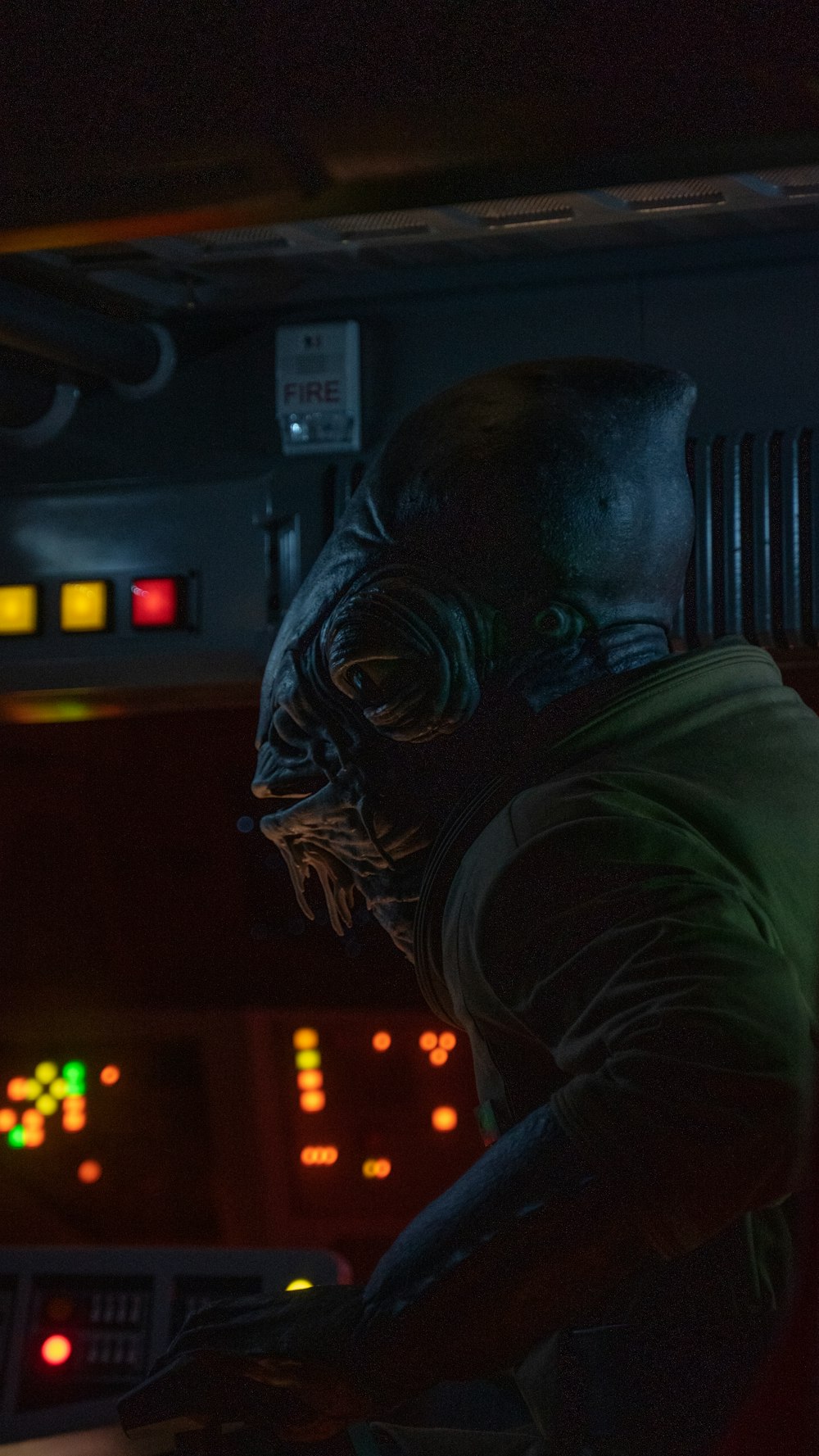 a man in a green shirt in a dark room