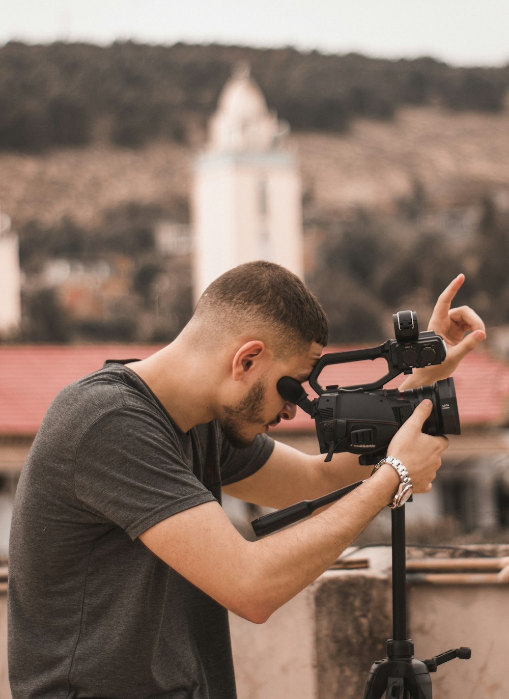 a man taking a picture with a camera on a tripod