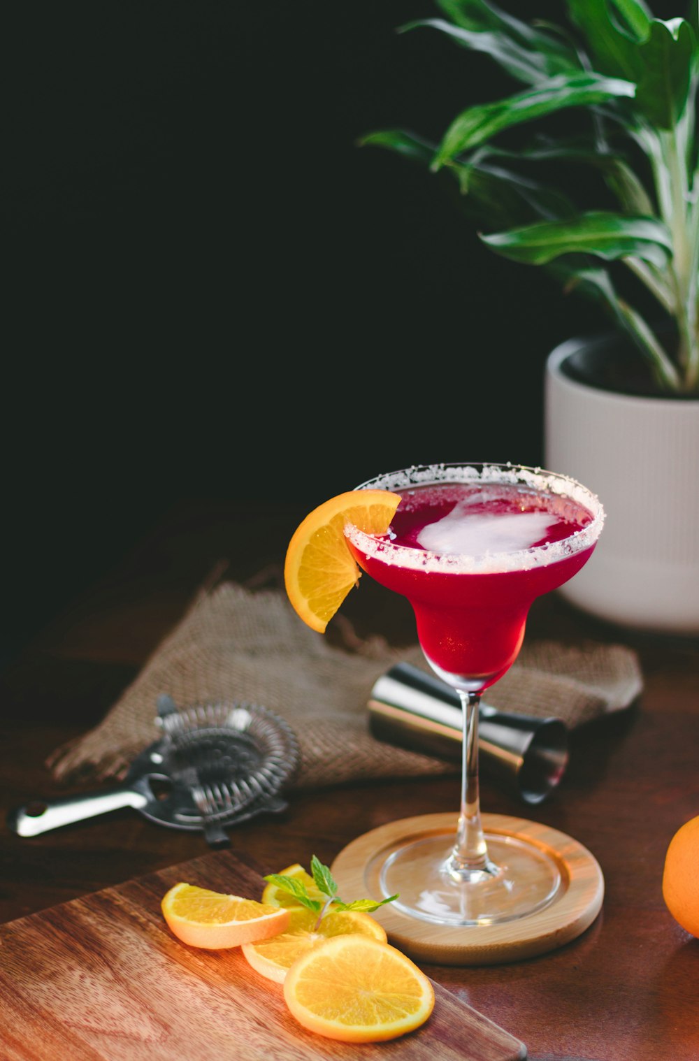 a red cocktail with a garnish garnish garnish garn