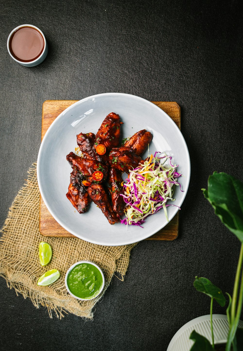 a white plate topped with chicken wings and cole slaw