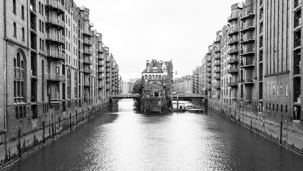 a river running through a city next to tall buildings