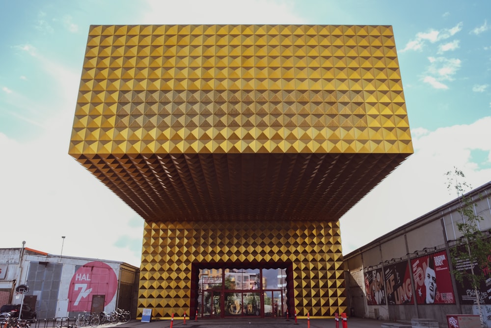 a large yellow structure with a sky background