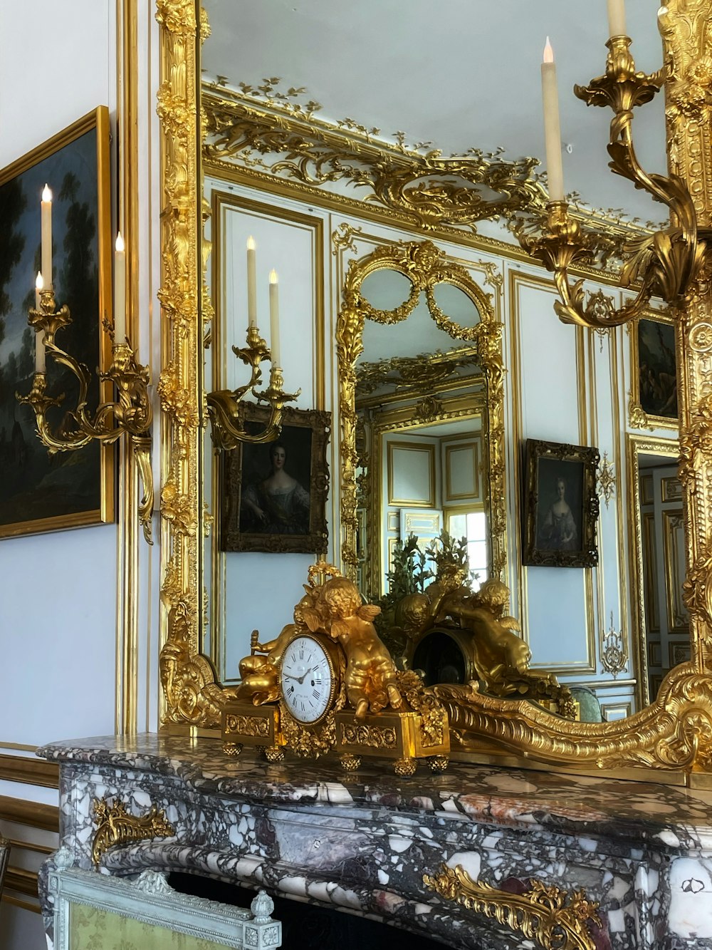 a large mirror with a clock on top of it