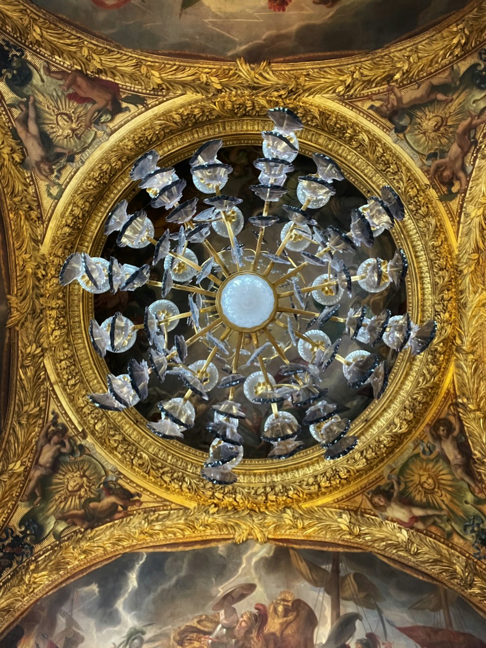 a ceiling in a building with paintings on it