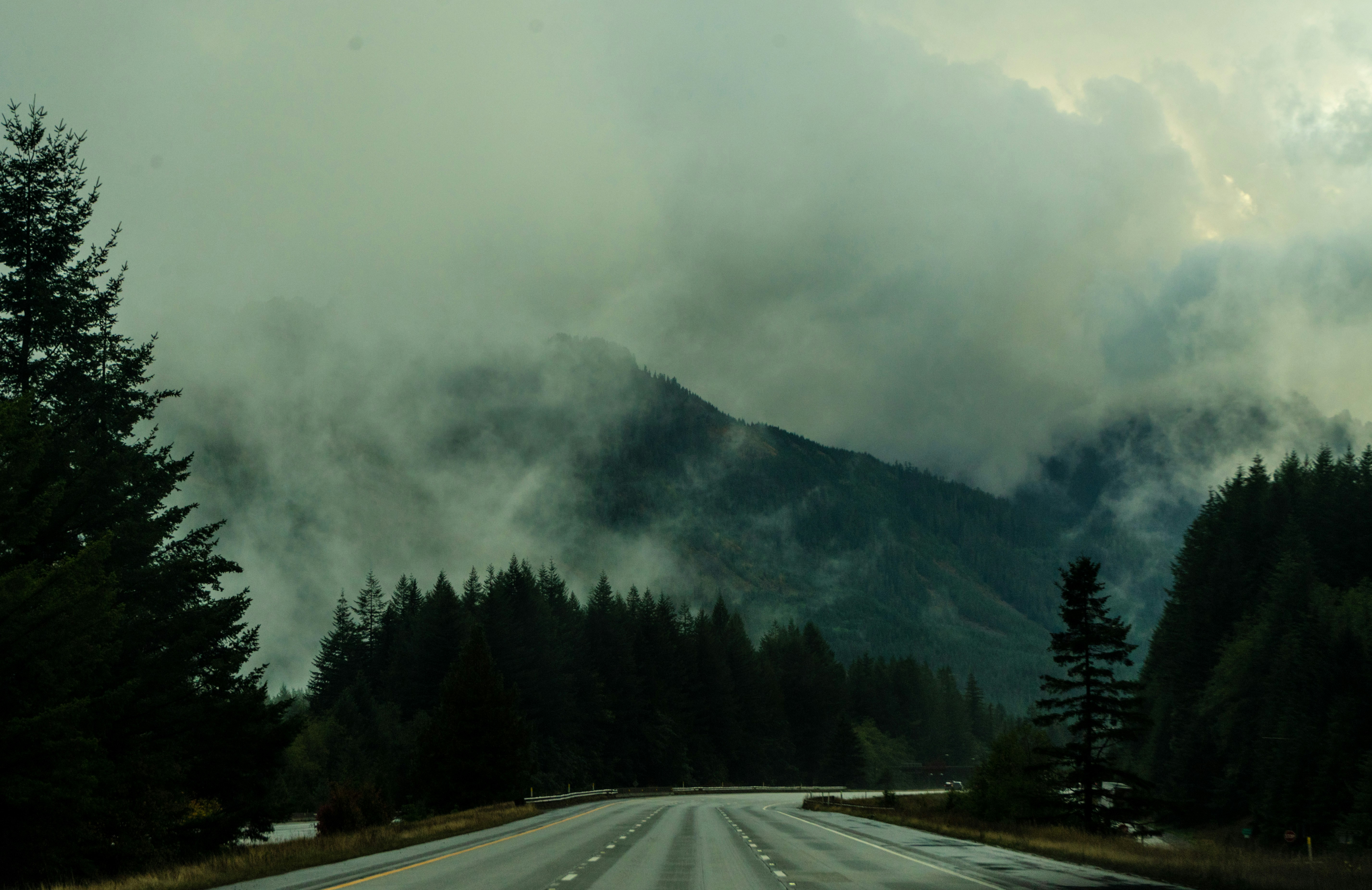 A road with a mountain in the background photo – Free Clouds Image on ...