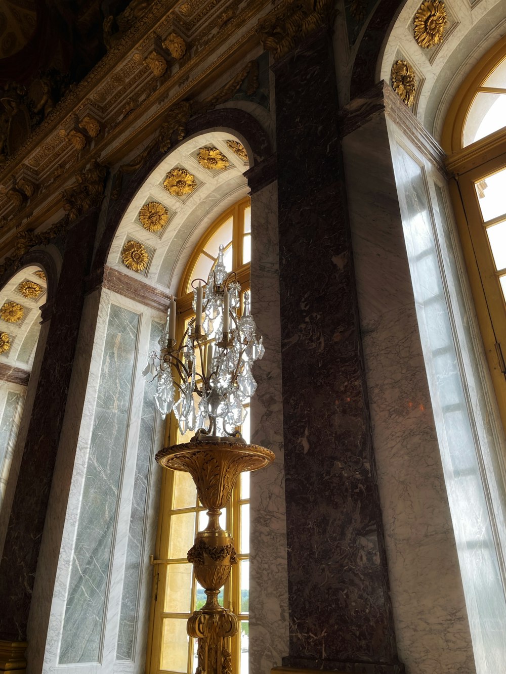 a chandelier in a room with two windows