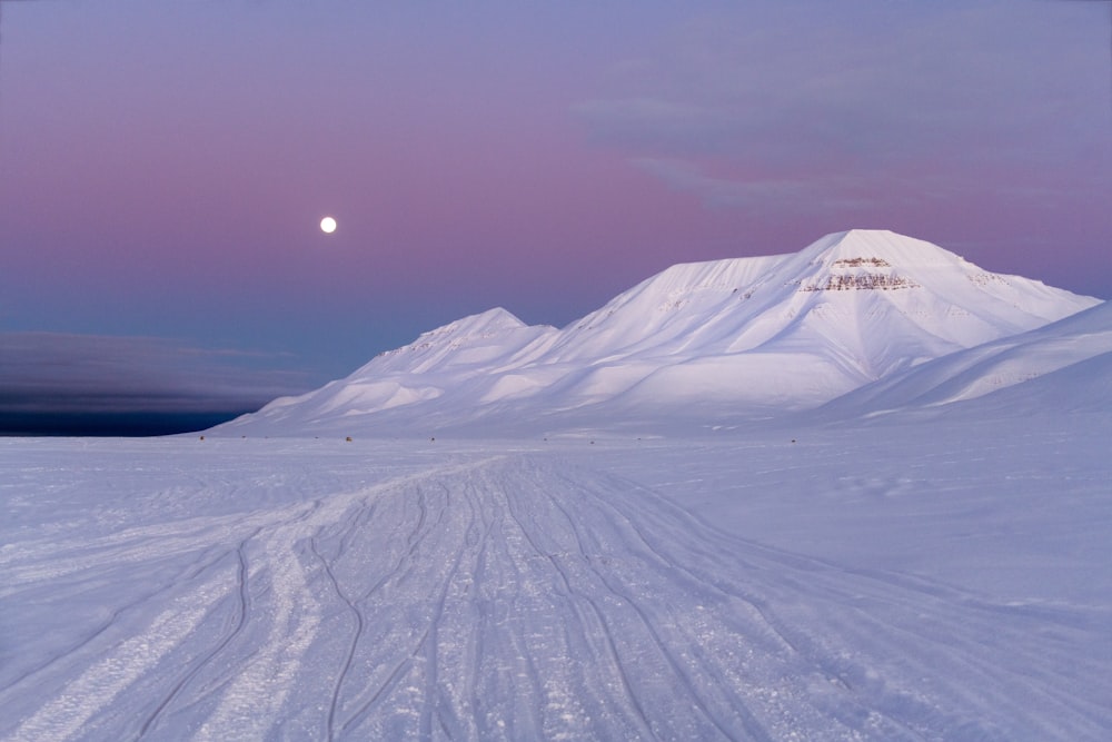 a person riding skis down a snow covered slope