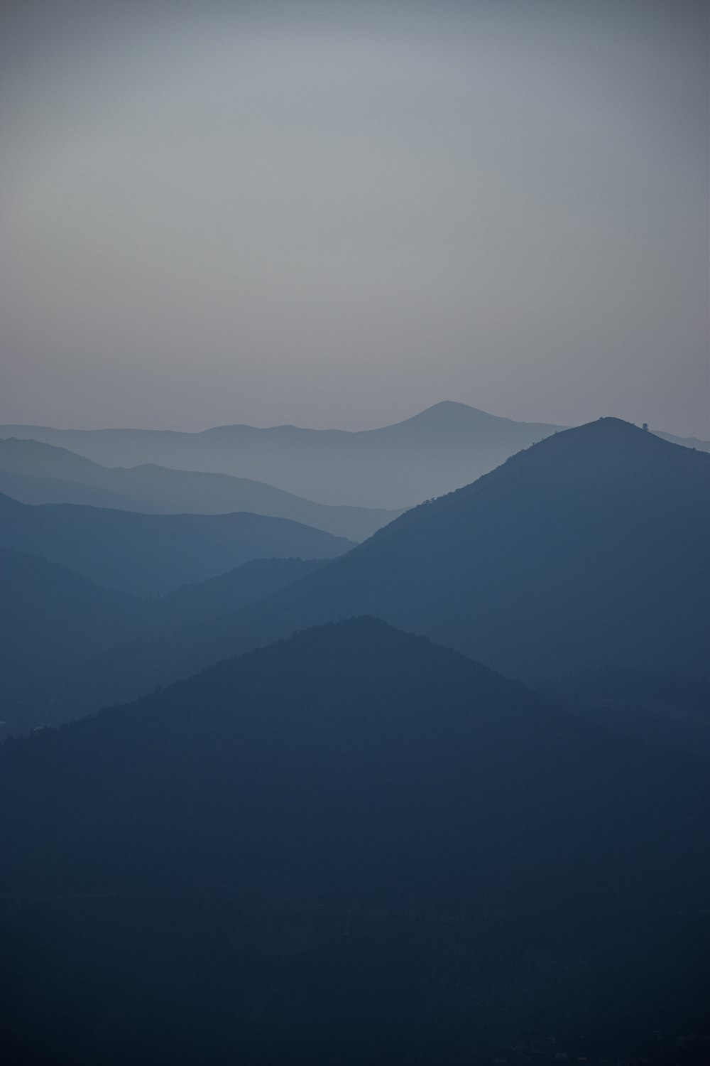 a view of a mountain range at dusk