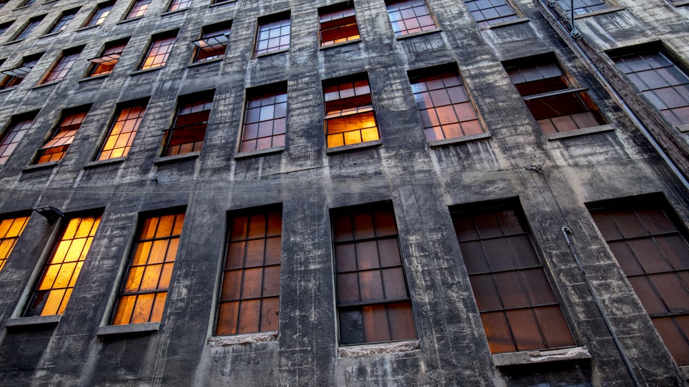 a tall building with lots of windows next to a street