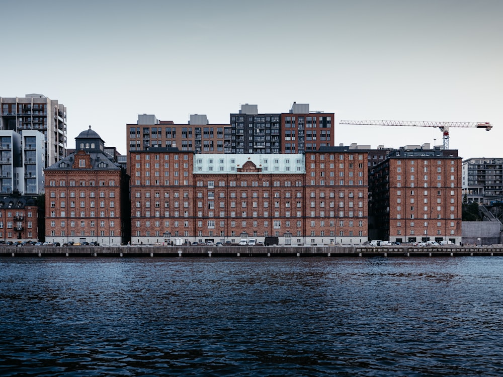 a large brick building sitting next to a body of water