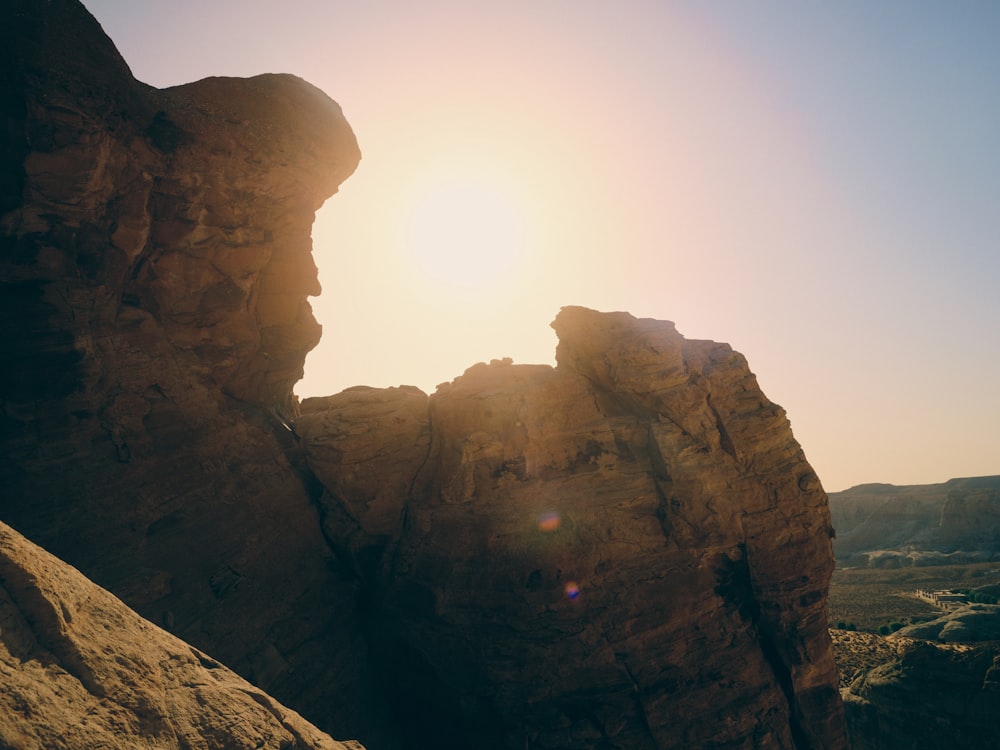 the sun is shining through the rocks in the desert