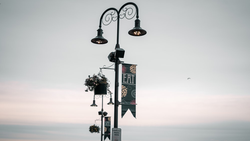 a street light with a sign hanging off of it's side