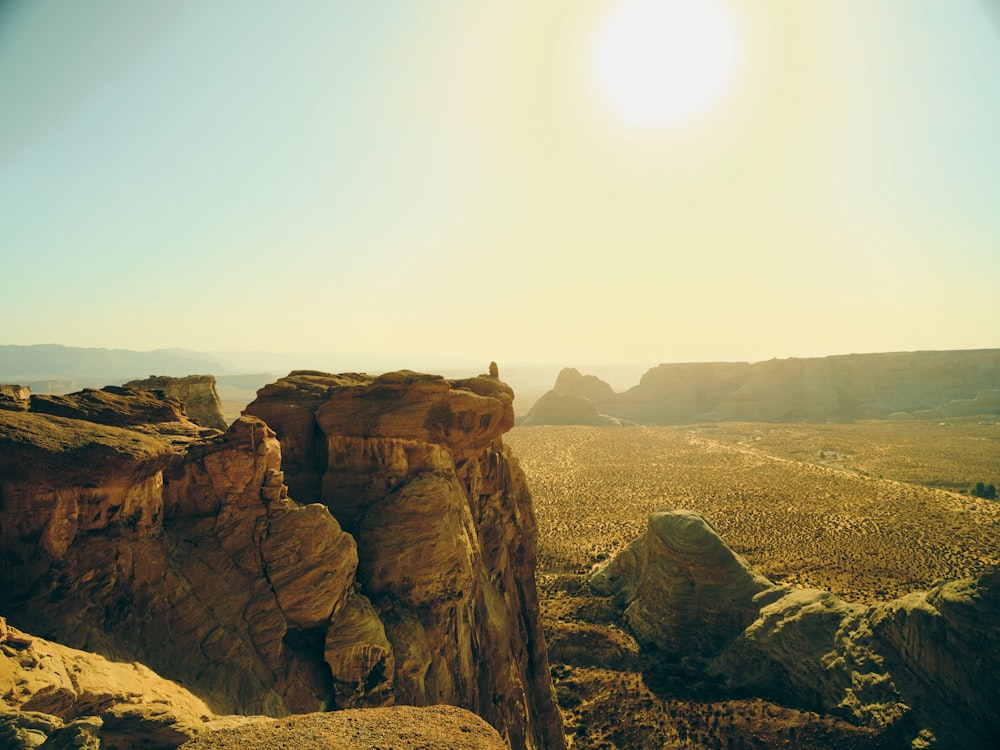 the sun is shining over the rocky terrain