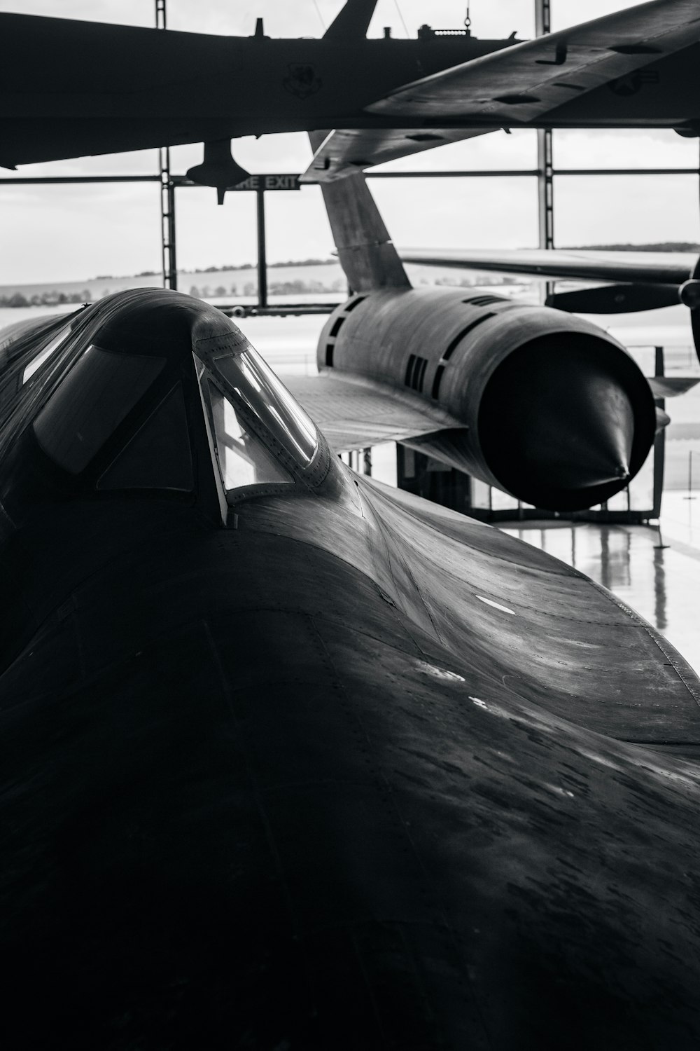 a black and white photo of an airplane in a hanger