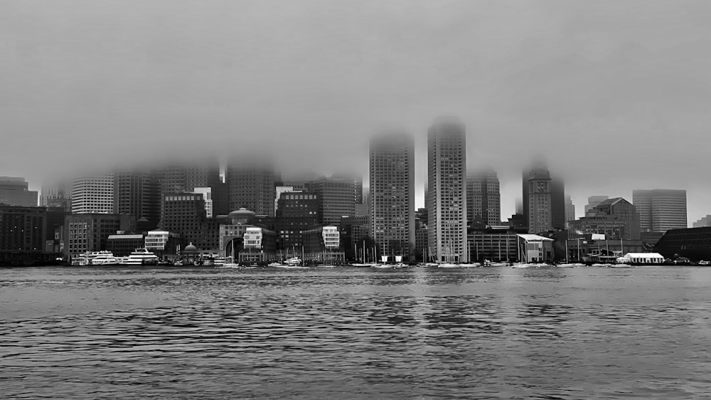 a black and white photo of a city on a foggy day