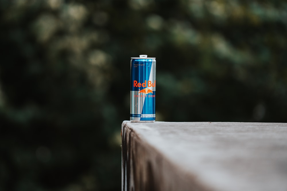 a can of soda sitting on top of a wooden table