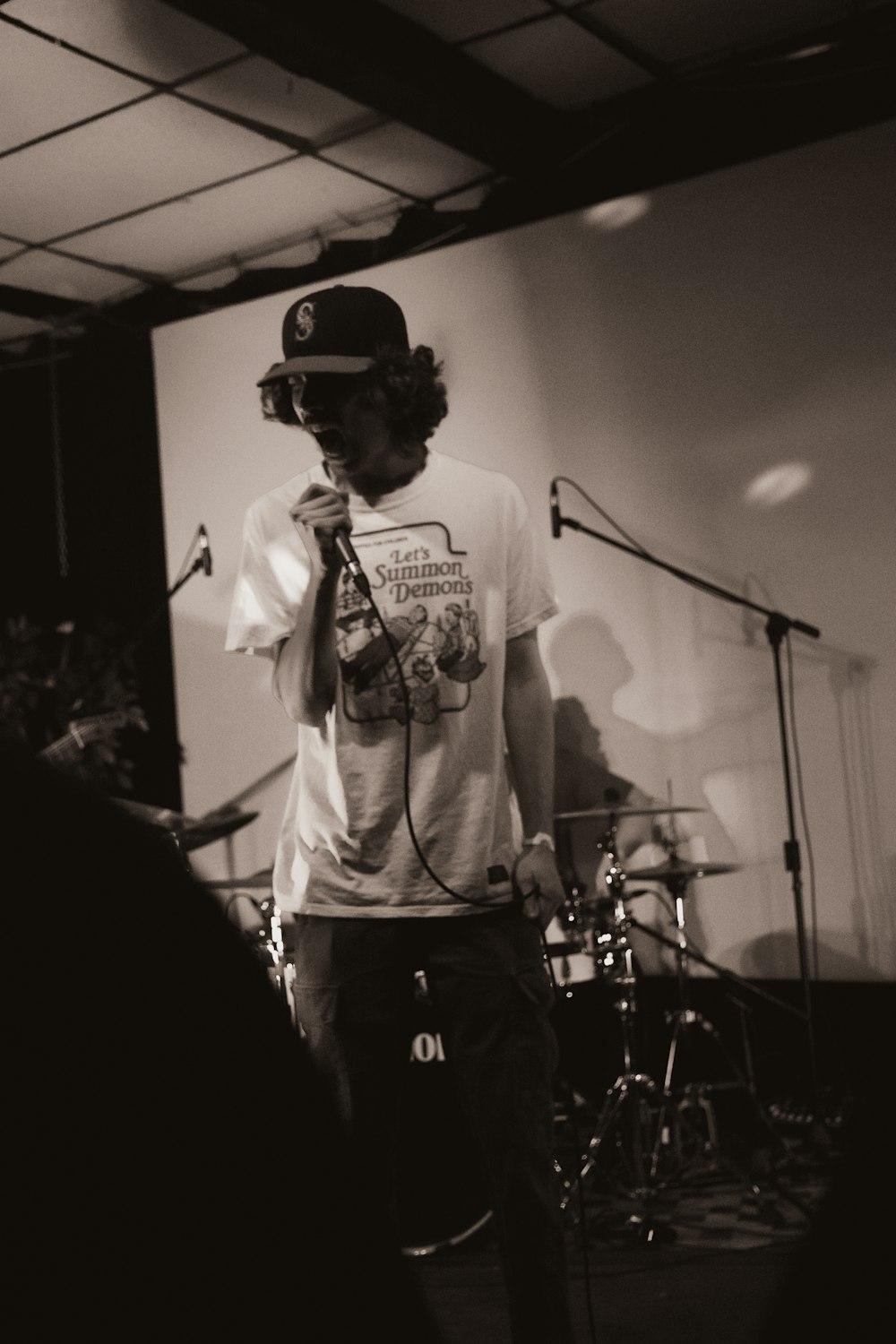 a man standing in front of a microphone on a stage