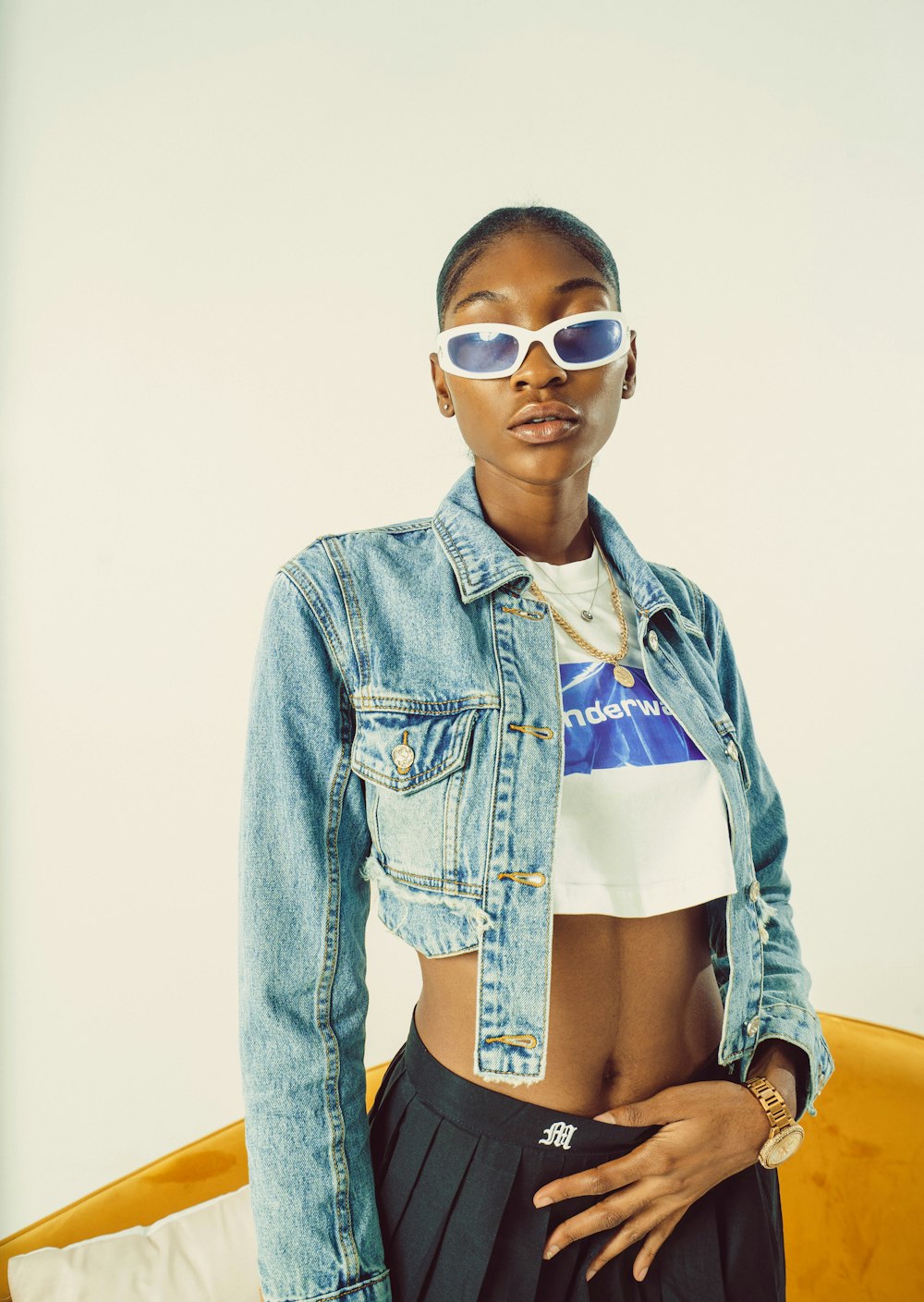 a woman wearing a jean jacket and sunglasses