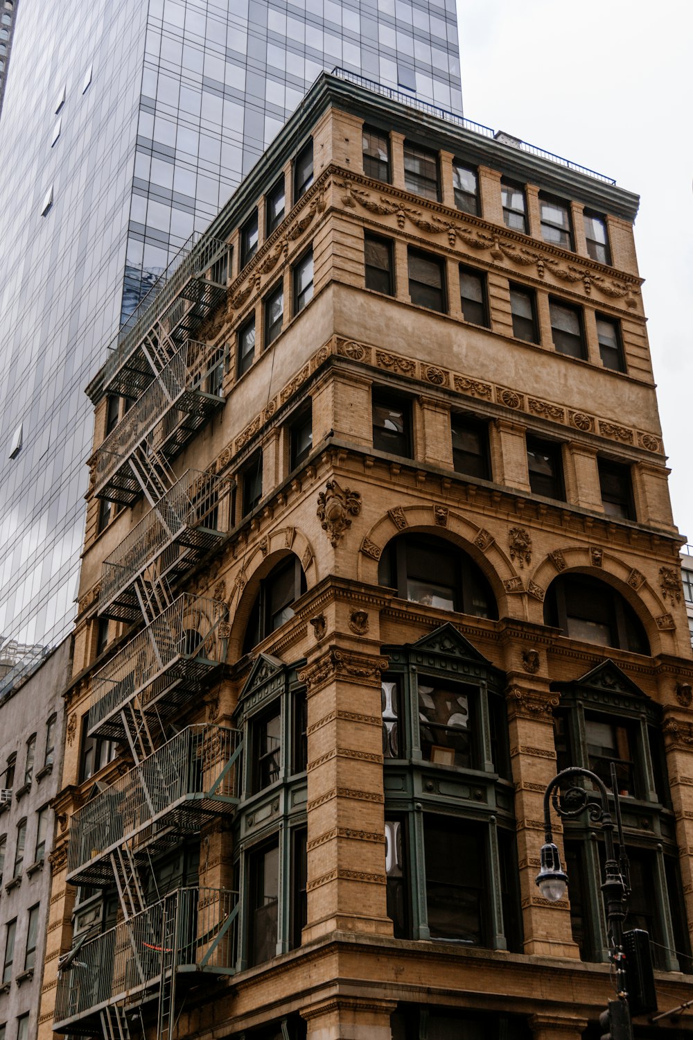 a tall building with a fire escape next to it