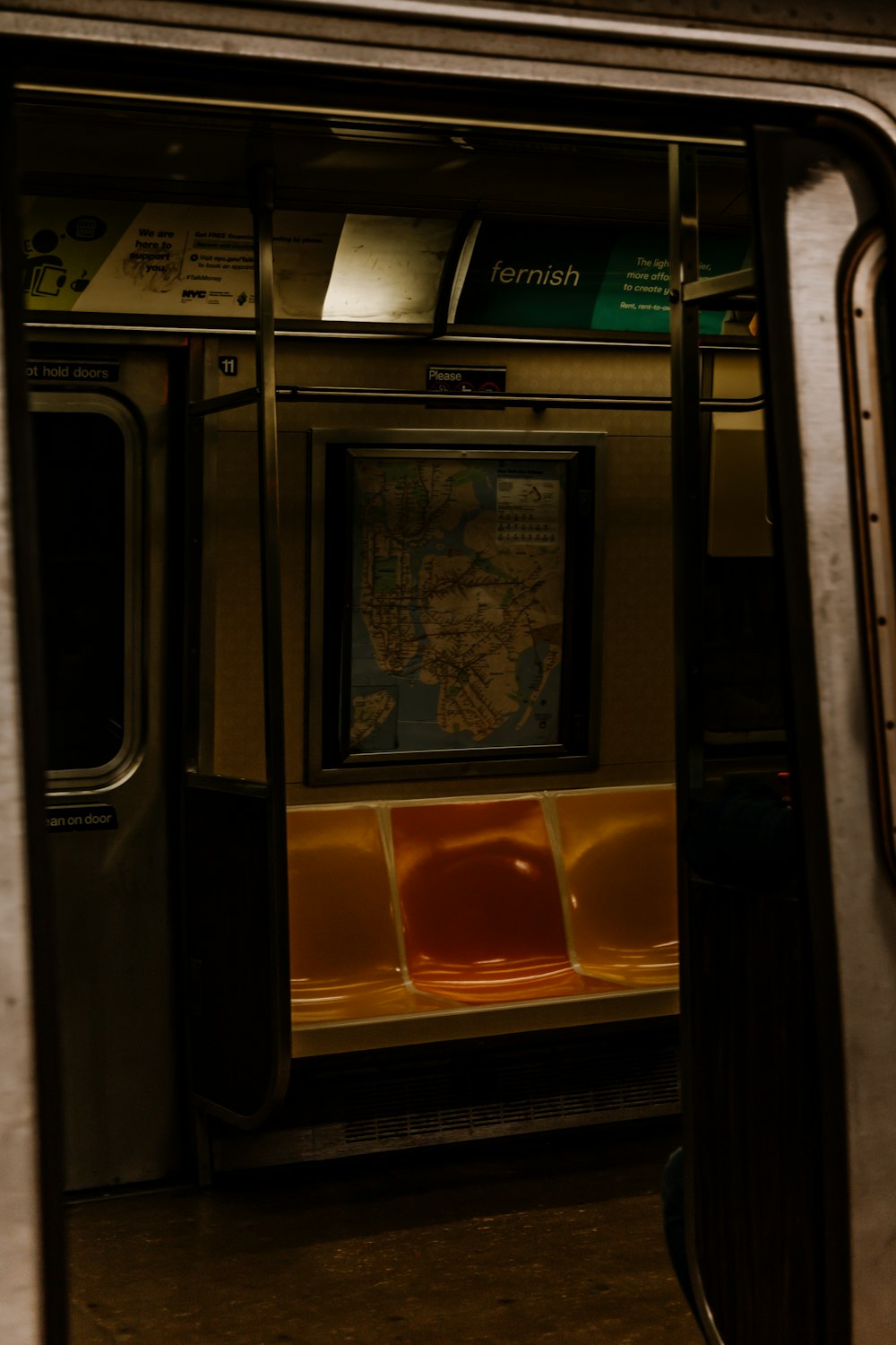 a subway car with a map on the wall