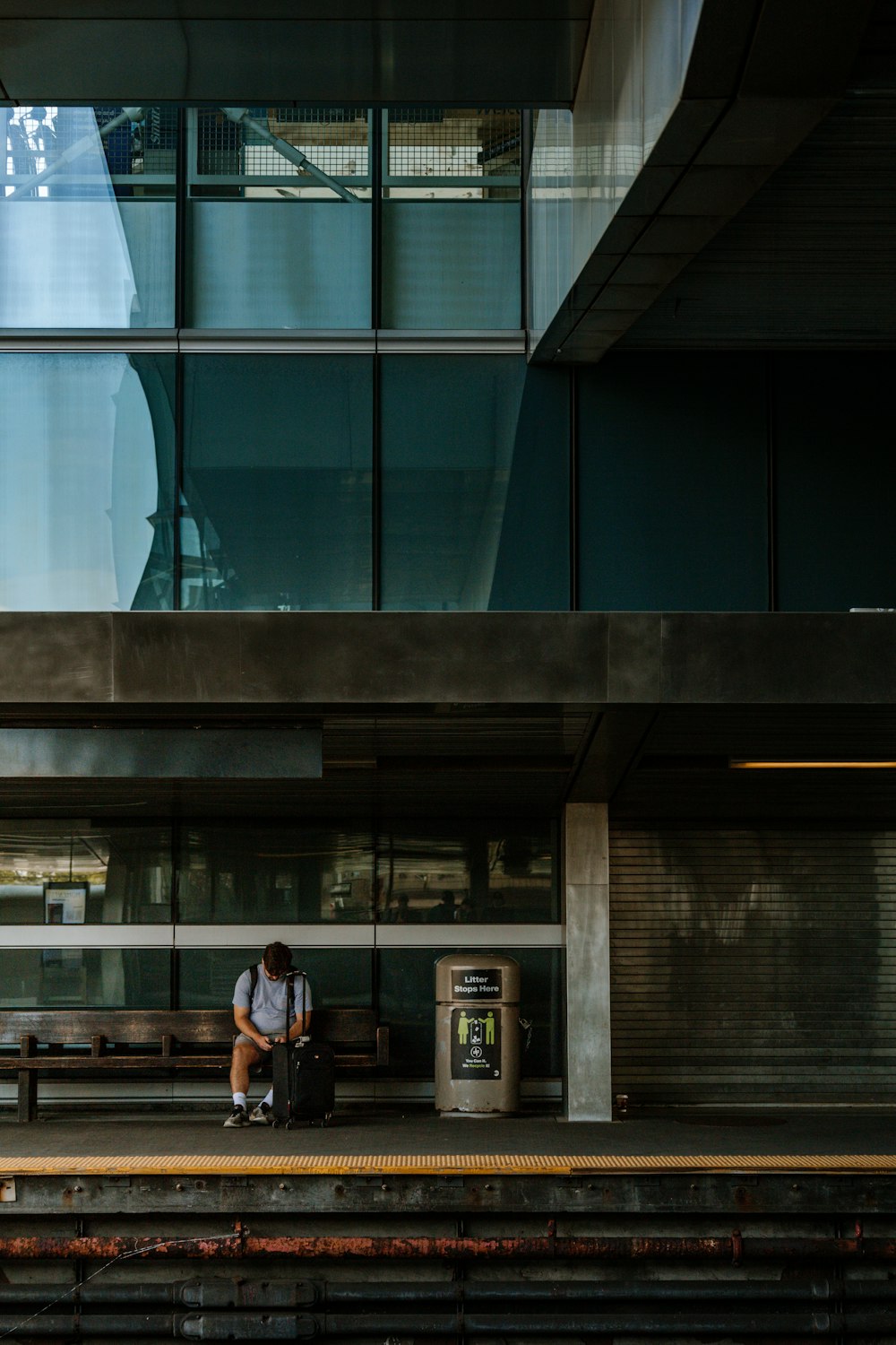 a man sitting on a bench in front of a building