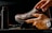 a person tying a pair of brown shoes