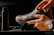 a person tying a pair of brown shoes