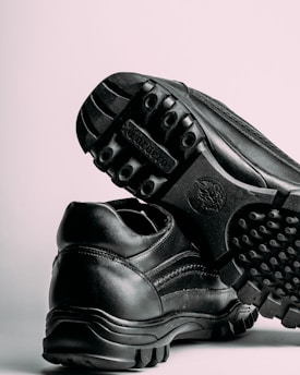 a pair of black shoes on a white background