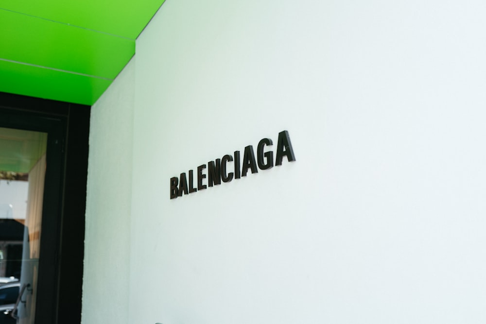 a white wall with a sign that says balenocaga on it