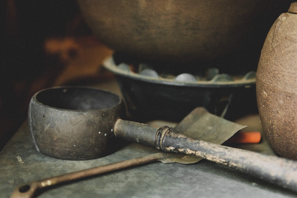 a table topped with pots and tools on top of a table