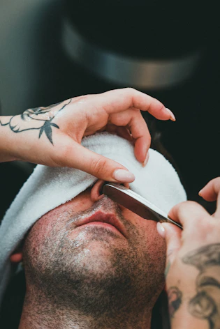 a man getting his hair cut by a barber
