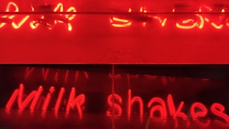 A casual tee in creamy vanilla tones with a subtle, custom embroidery of the word 'milkshake' in cursive.