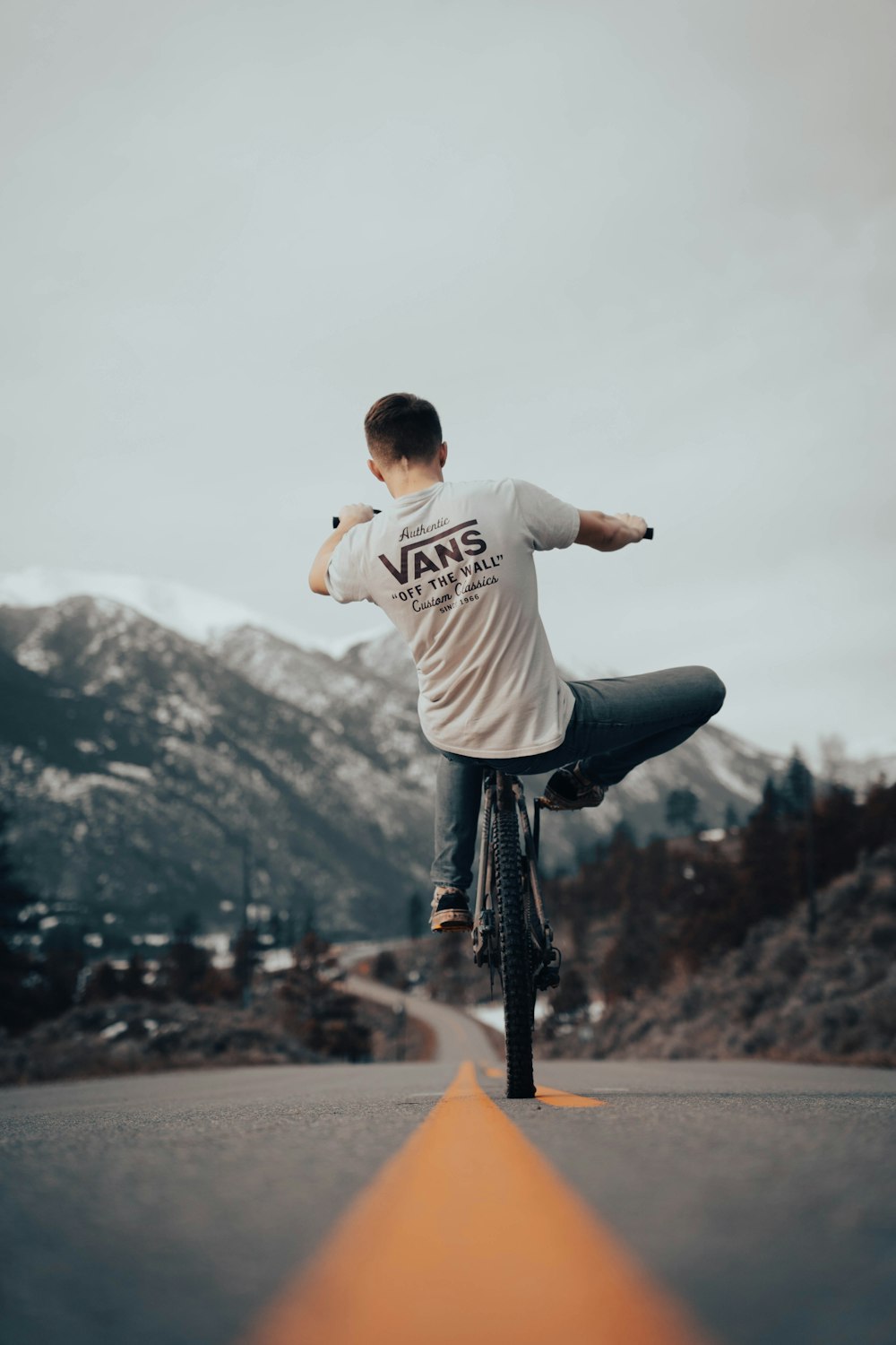 a man riding a bike down a street