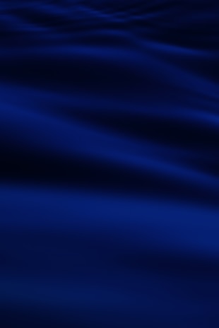 a blurry photo of a blue ocean with waves