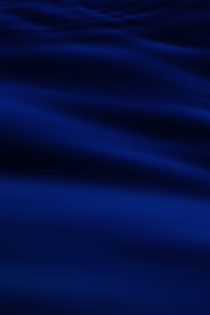 a blurry photo of a blue ocean with waves