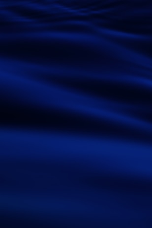 a blurry photo of a blue ocean with waves