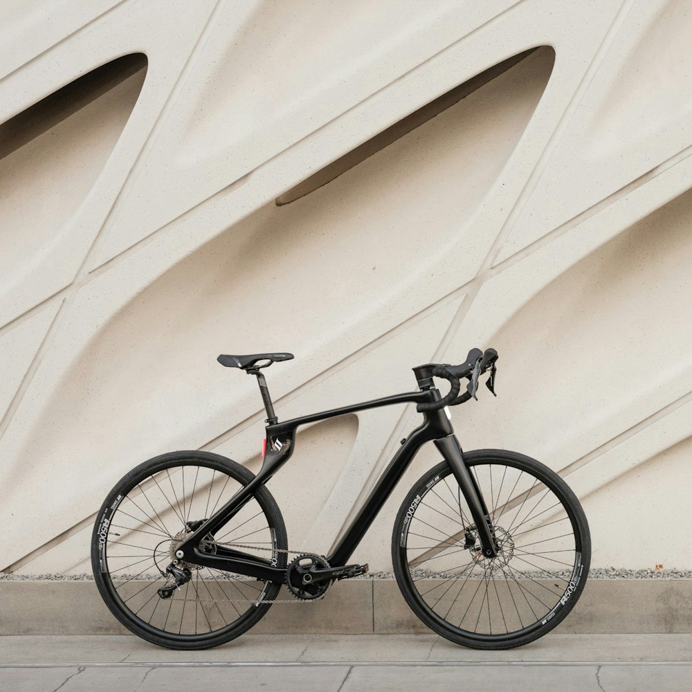 a black bike parked in front of a building