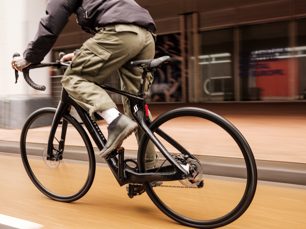 a man riding a bike down a street