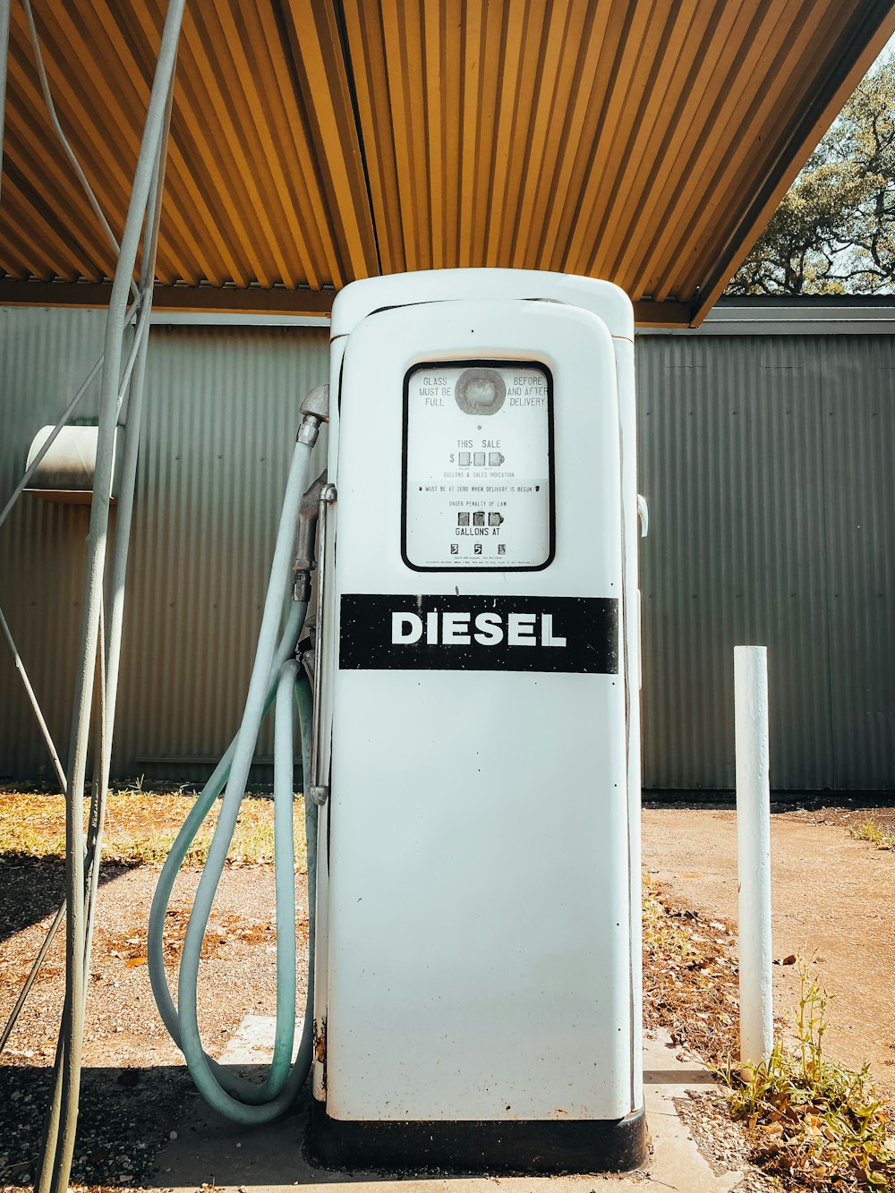 an old diesel gas pump with a hose hooked up to it