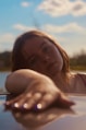 a woman leaning on the hood of a car